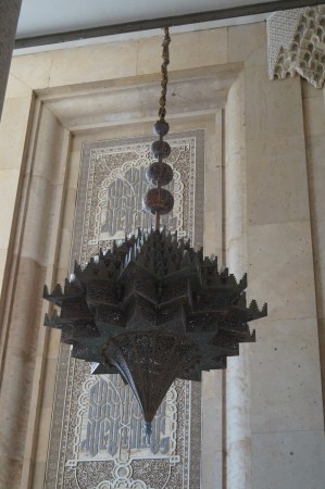 The stairway down is lit by several of these massive titanium and brass chandeliers.
