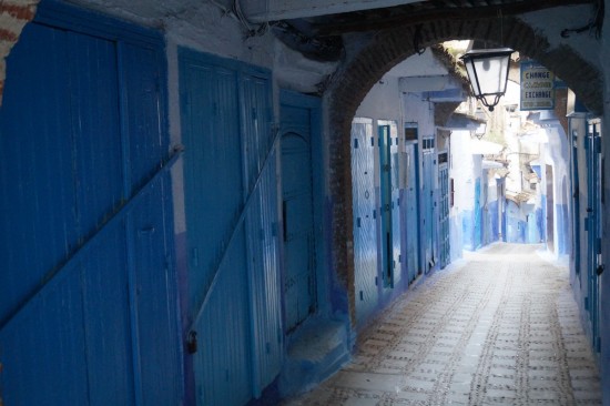 In the morning, the streets are deserted and the shops are closed up, revealing their blue doors.