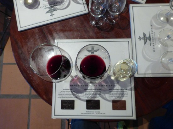 The wine and chocolate pairing. Two reds and a dessert wine, each with their own little rectangle of chocolate.