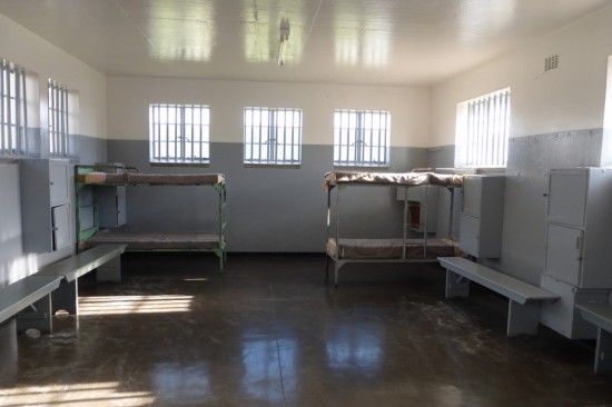 The communal cell area where 40+ prisoners slept on the concrete floor. The beds were added in the late 1970s.