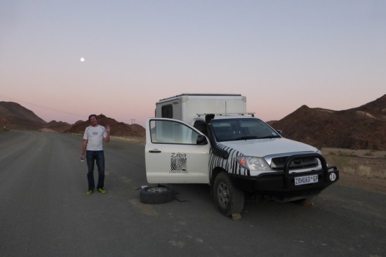 Changing the tire as the sun sets and the moon rises. Gorgeous scenery for a tire change, though!